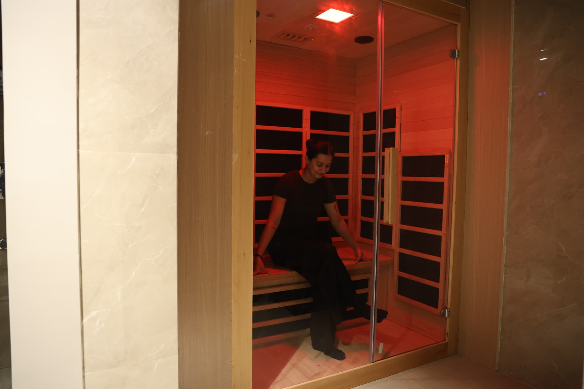 Red light sauna room glowing warmly through raking light